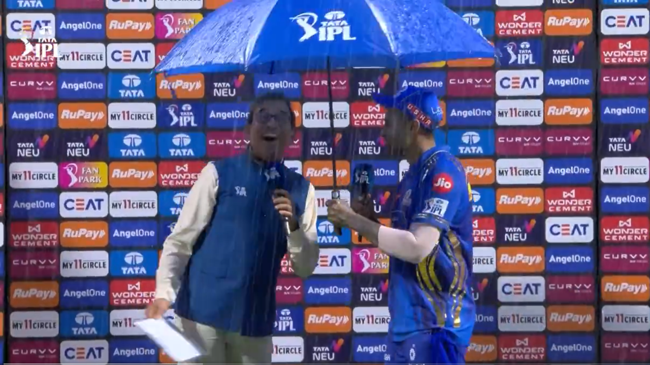 Suryakumar Yadav Holds Umbrella For Harsha Bhogle While Receiving Player Of The Match After MI Vs DC IPL 2025 Clash 1 Suryakumar Yadav Holds Umbrella For Harsha Bhogle While Receiving Player Of The Match After MI Vs DC IPL 2025 Clash 1