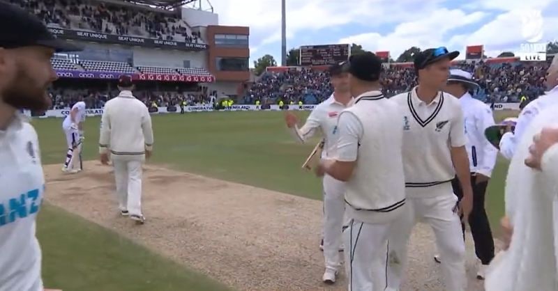 Joe Root hands over a stump to Daryl Mitchell as a fitting gesture 